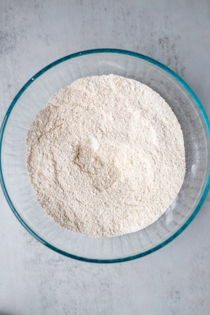 wheat flour, baking soda, baking powder, and salt in a glass mixing bowl.