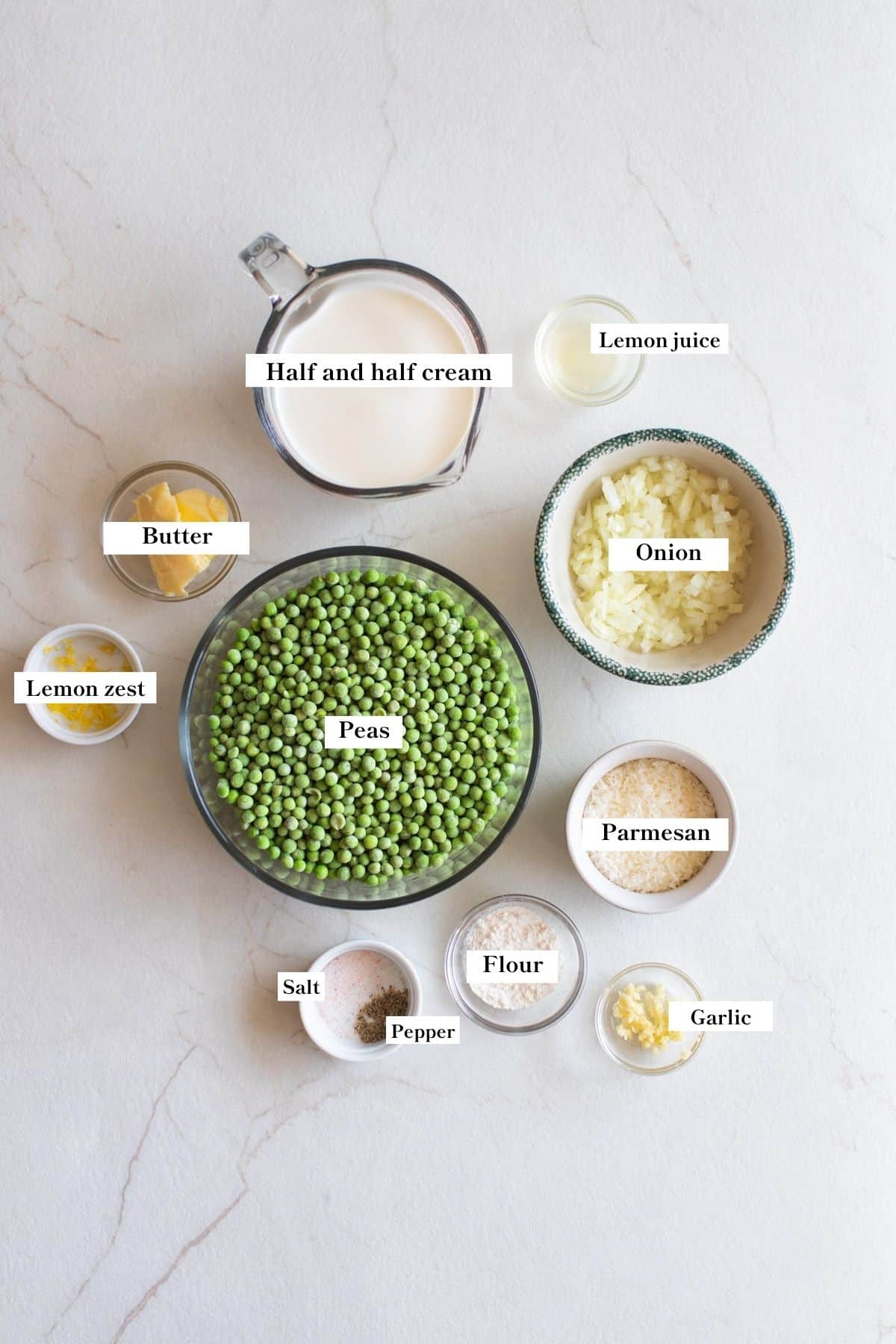 Bowls with ingredients for cream peas on a counter top.
