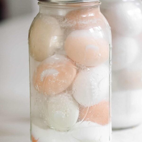 Two jars with eggs in a lime solution.