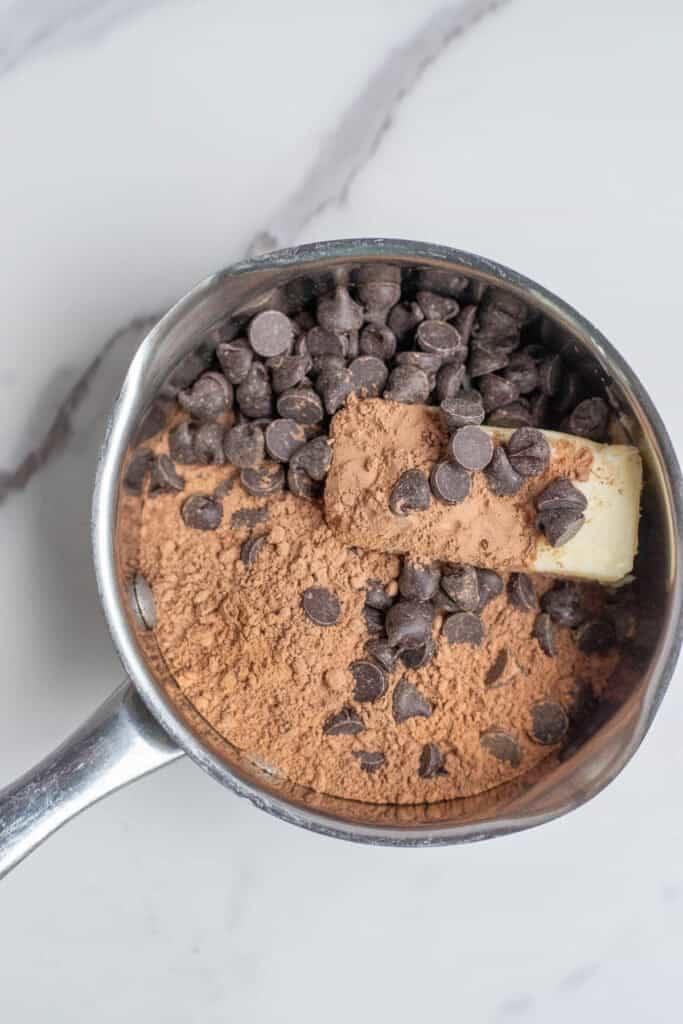 Cocoa powder, butter, sugar, and chocolate chips in a pot to melt.