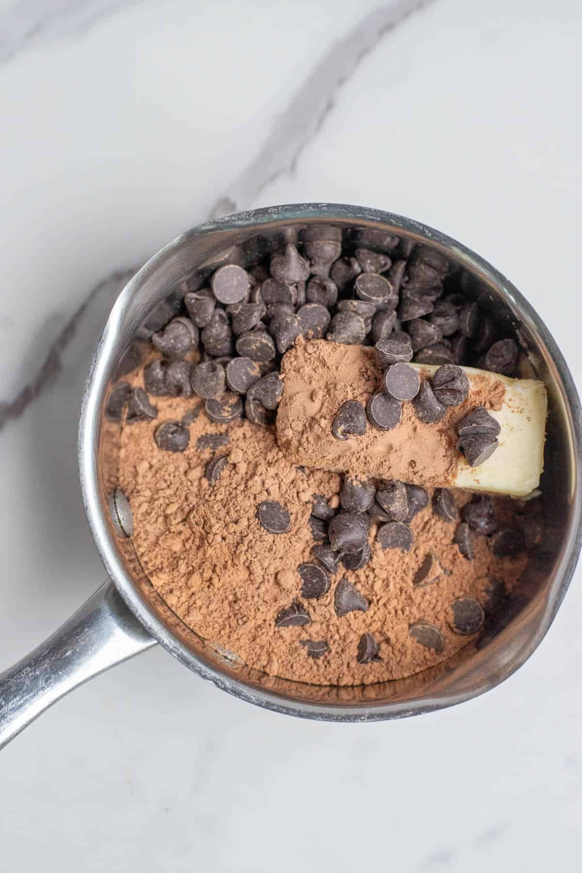 Cocoa powder, butter, sugar, and chocolate chips in a pot to melt. 