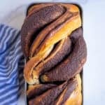 freshly baked sourdough babka on a marble countertop.