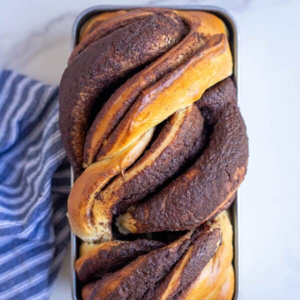 freshly baked sourdough babka on a marble countertop.