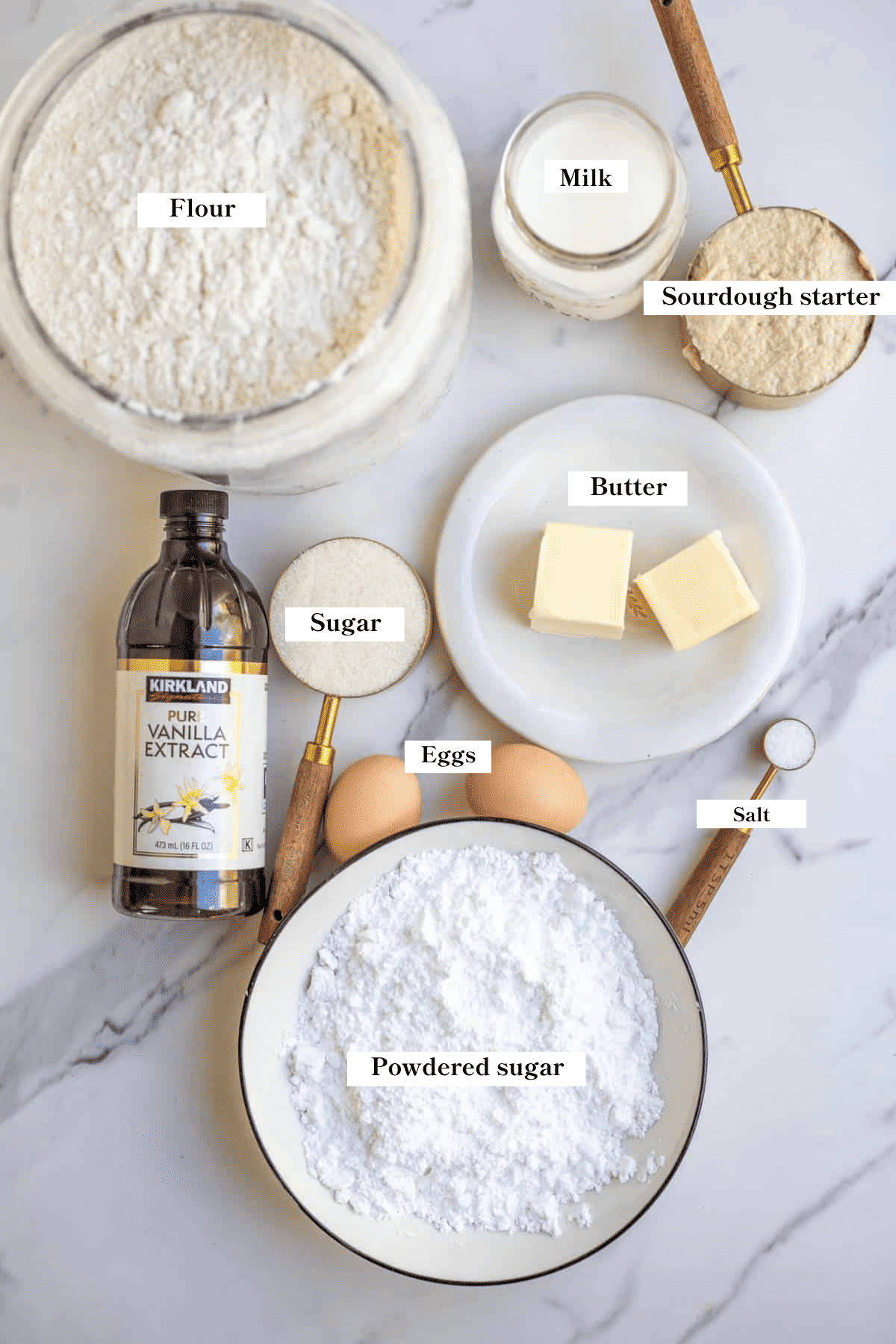 Ingredients for sourdough donuts in small bowls on the countertop.