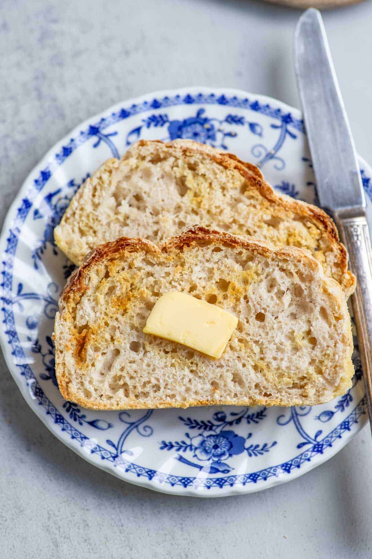 Two slices of English muffin bread on a blue and white plate.
