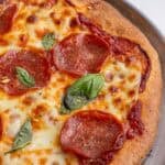 A half pizza on a pizza pan.