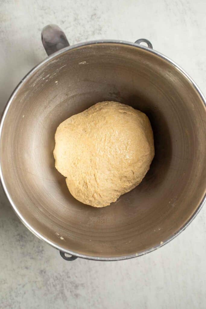 A dough ball in a stand mixer bowl.