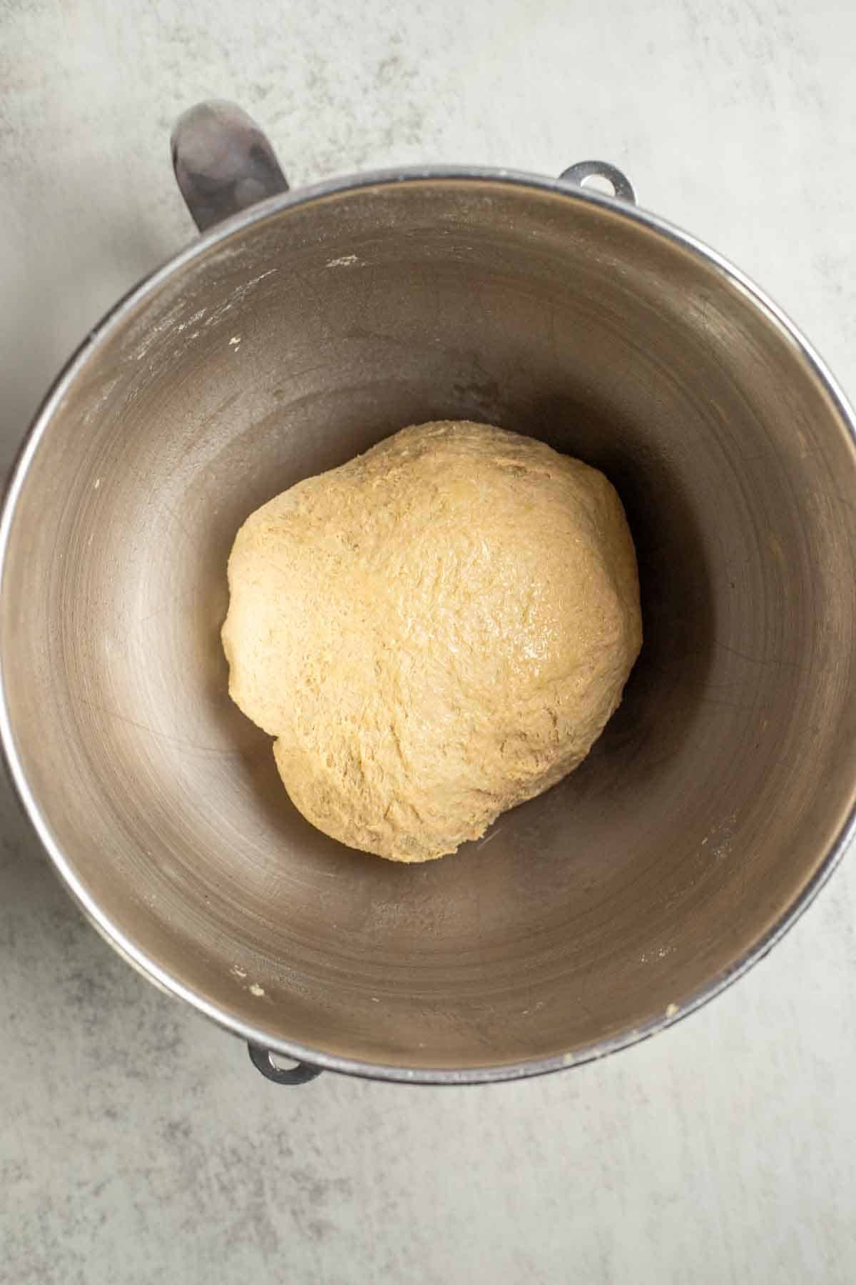A dough ball in a stand mixer bowl.
