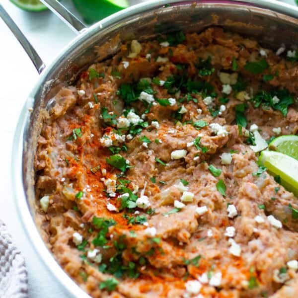 Homemade refried beans in a sauce pan on the counter.