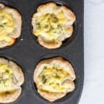 Baked mini quiches in a muffin tin.