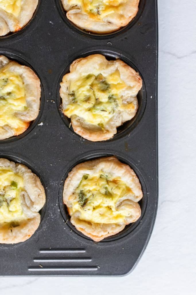 Baked mini quiches in a muffin tin.