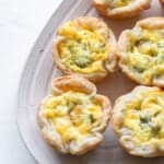 Mini quiches on a serving platter.