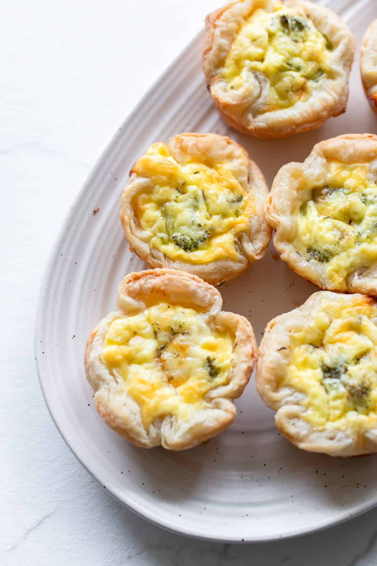 Mini quiches on a serving platter.