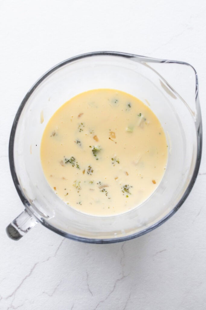 Egg mixture with add ins in a glass large measuring bowl.