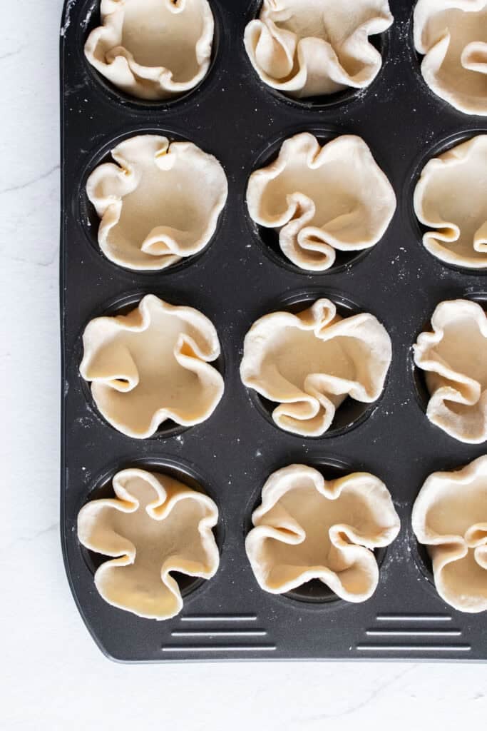 Pie crust in muffin tins.