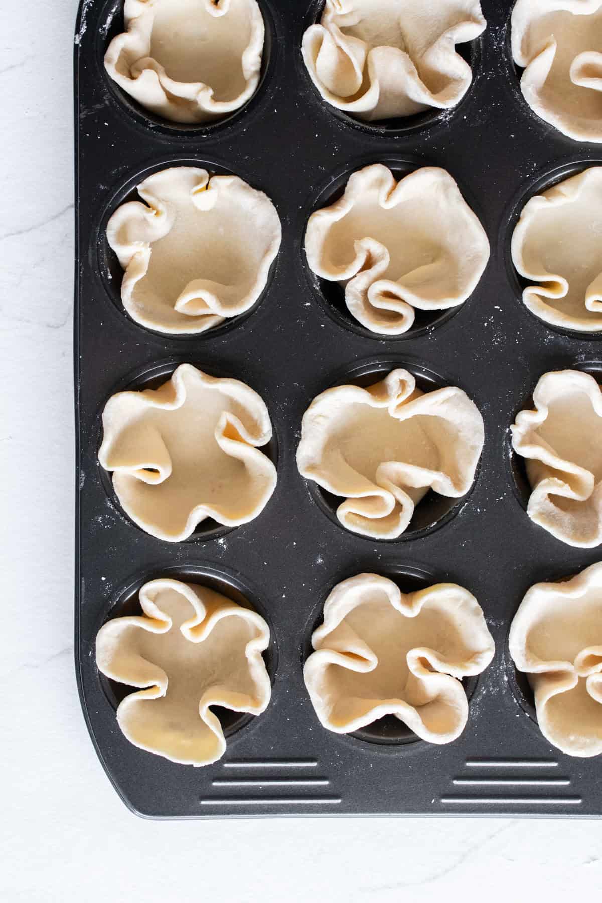 Pie crust in muffin tins.
