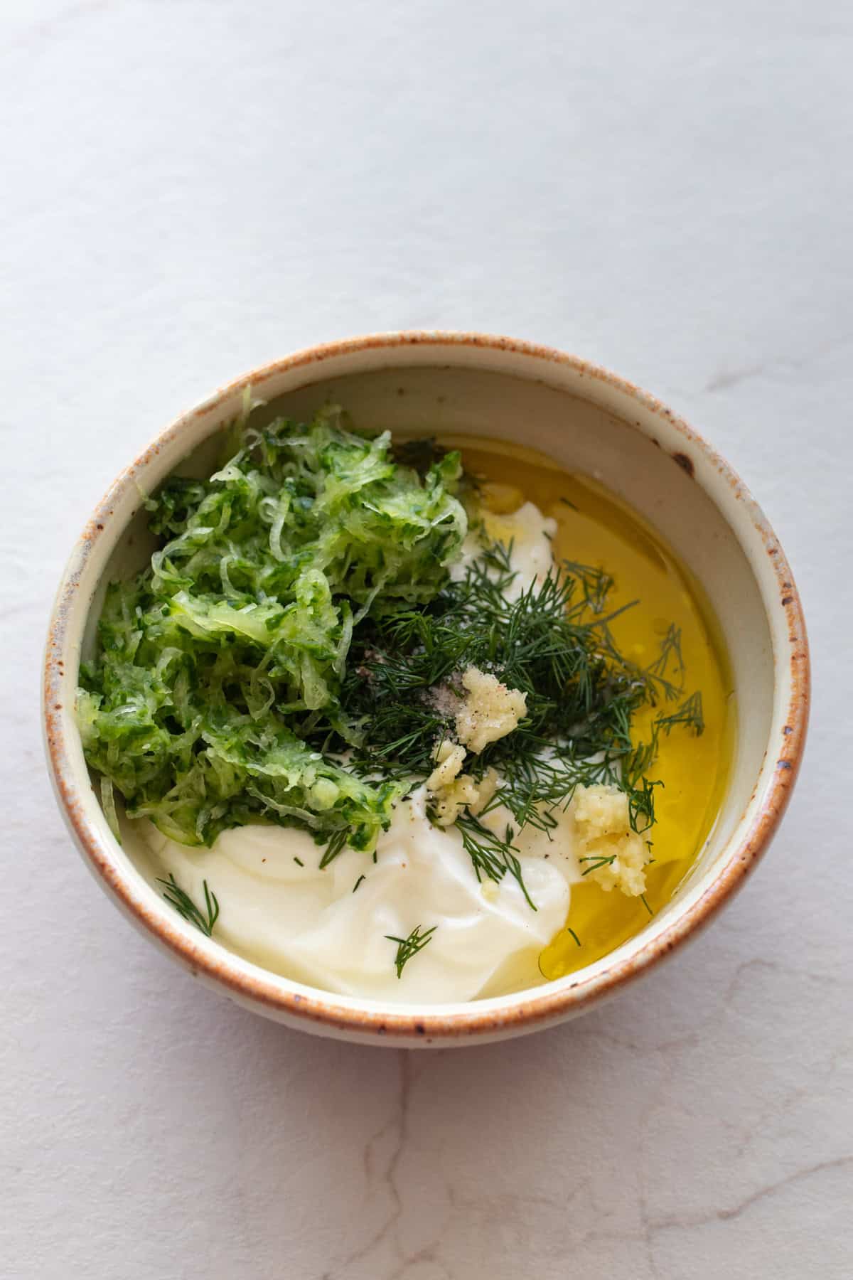 Cucumber and other ingredients in a bowl.