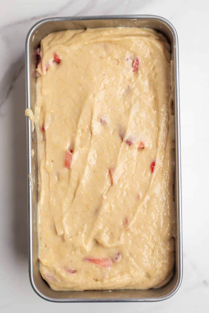 Quick bread batter spread into a loaf pan.