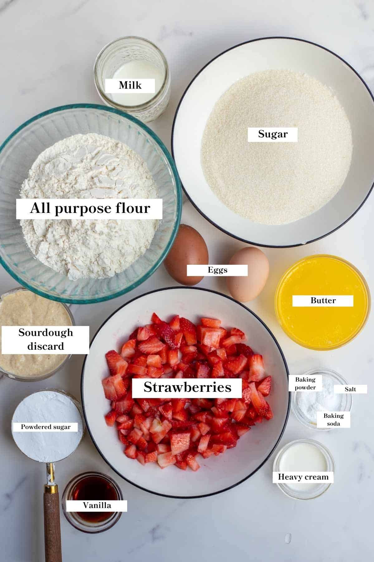 Ingredients in bowls for sourdough strawberry bread on a counter top.
