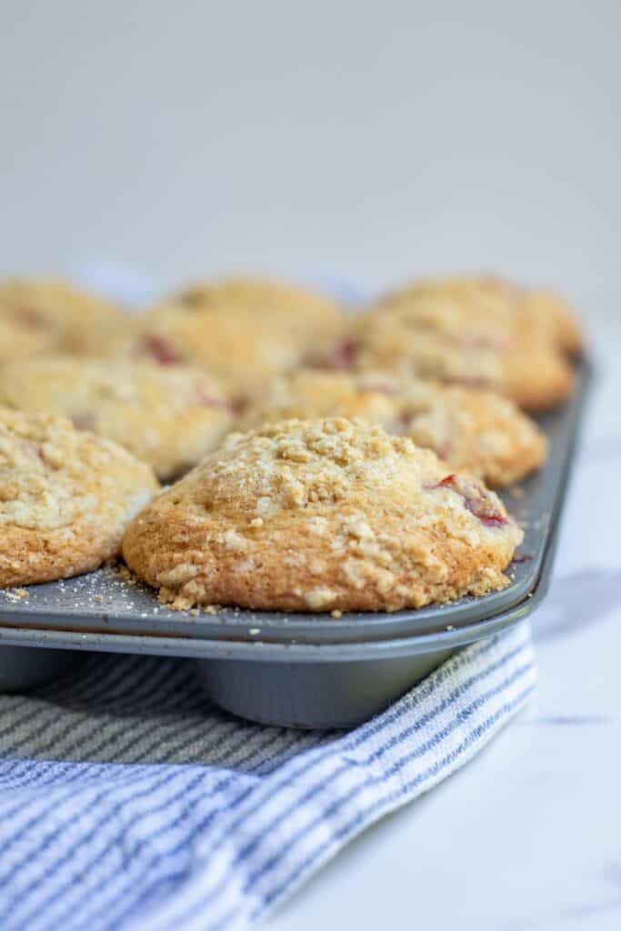 Fully cooked sourdough strawberry muffins in a muffin tin.