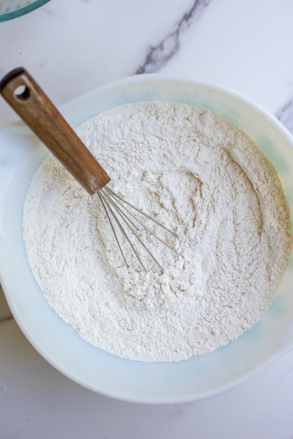 Flour, salt, and baking soda mixed together in a bowl.