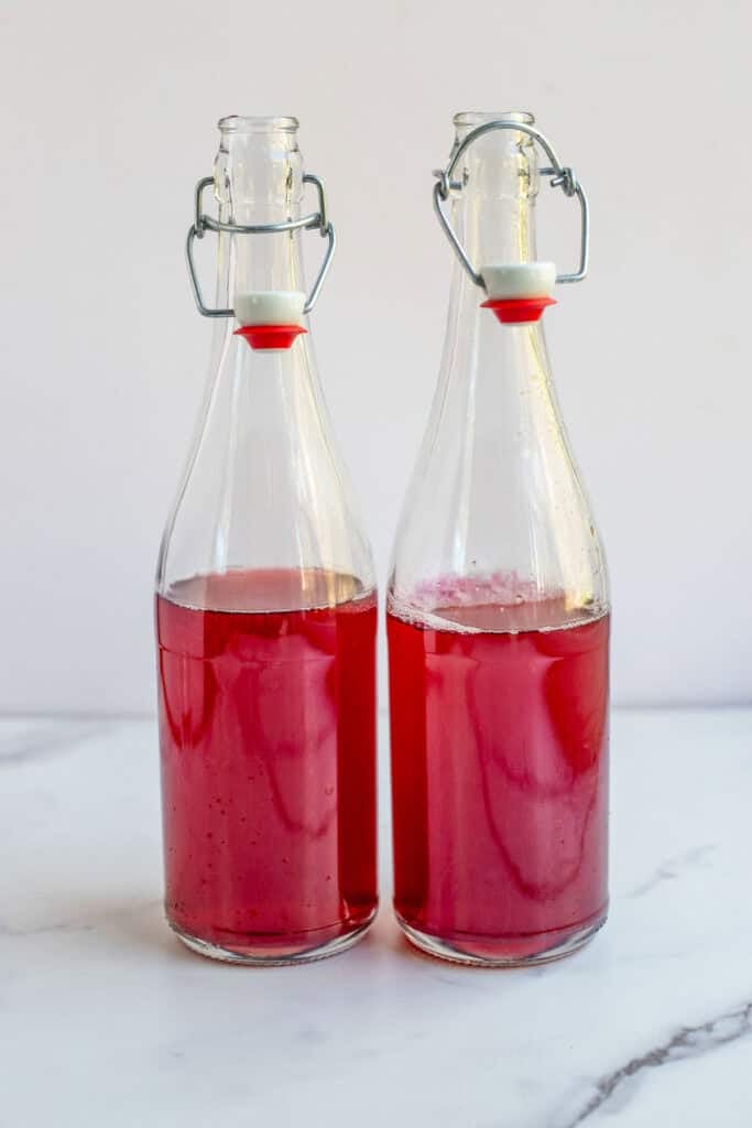 Water kefir and juice in a glass flip top bottle. 