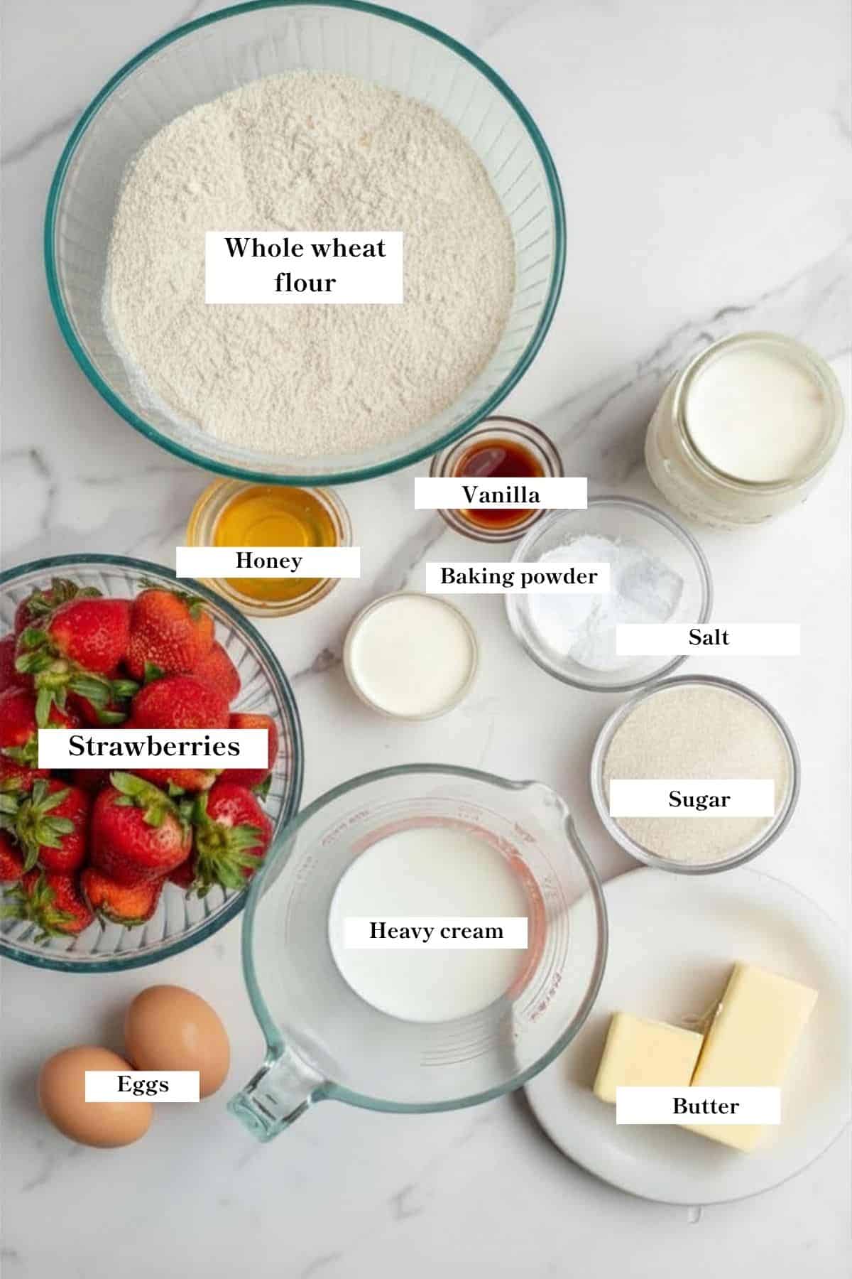Bowls of ingredients for strawberry shortcake on the counter.