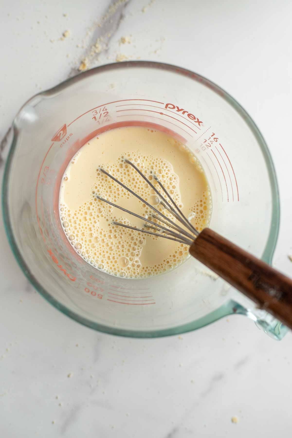Wet ingredients mixed together in a measuring cup.