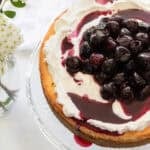 A cheesecake on a cake stand.