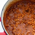 A Dutch oven of baked beans in sauce.