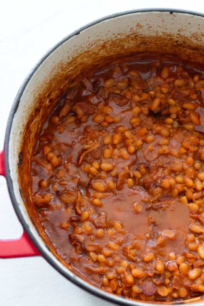A Dutch oven of baked beans in sauce.