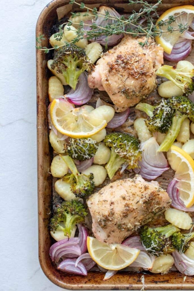 A sheet pan of homemade gnocchi, chicken, and veggies.