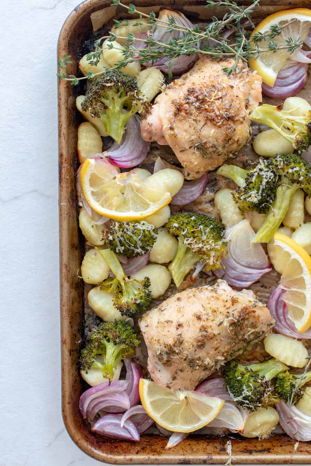A sheet pan of homemade gnocchi, chicken, and veggies.