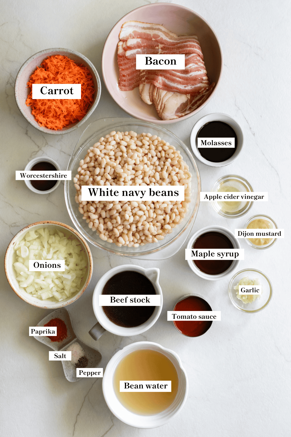 Ingredients for baked beans in bowls on a counter top.