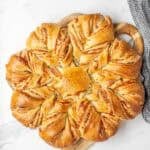 fully baked sourdough cheese star on white marble countertop.