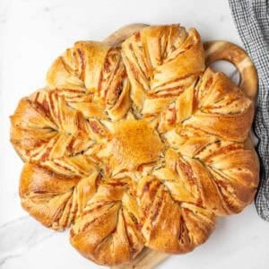 fully baked sourdough cheese star on white marble countertop.