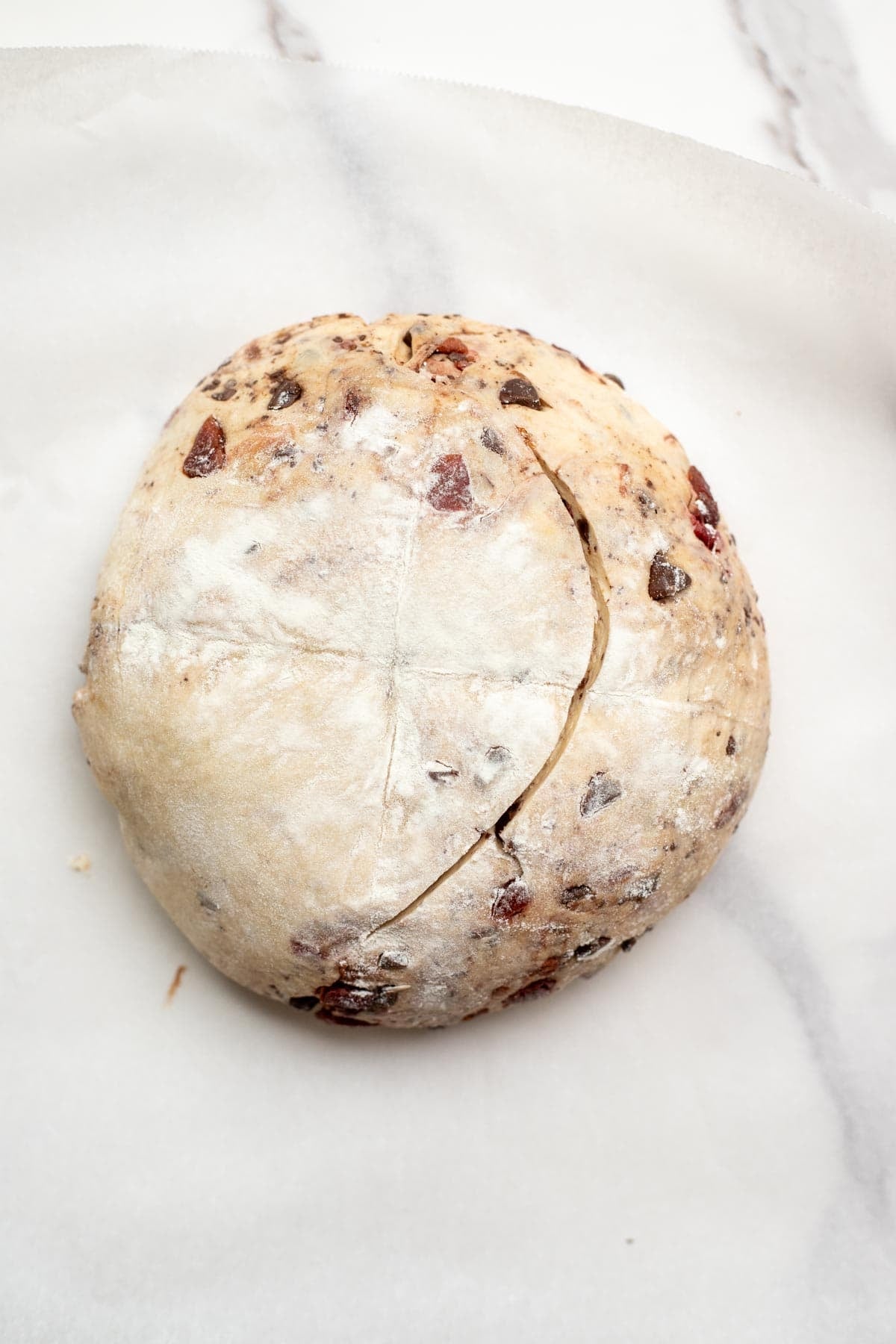 Scoring the chocolate cherry sourdough bread before baking.