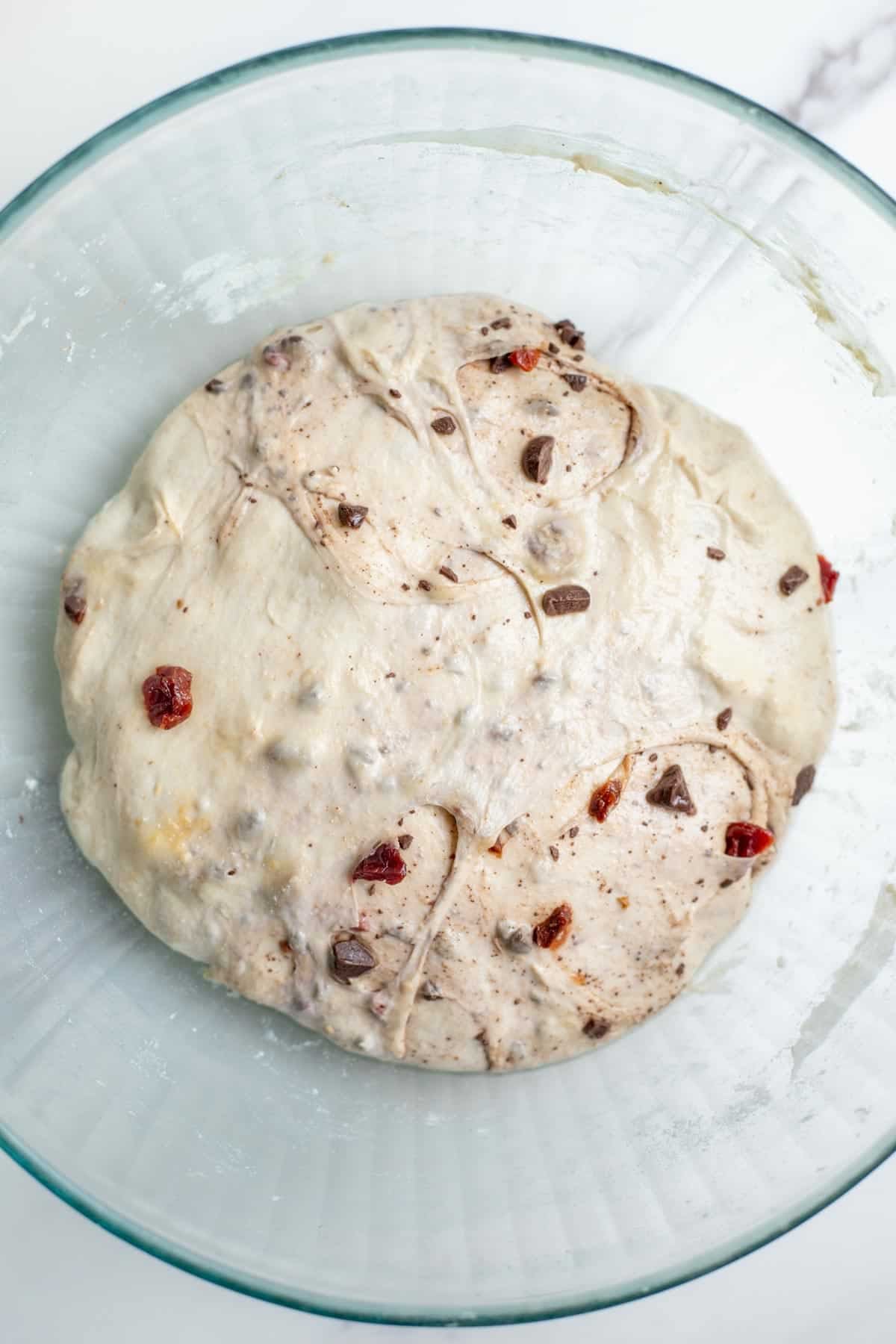 Chocolate cherry sourdough proofed in a glass bowl until doubled.