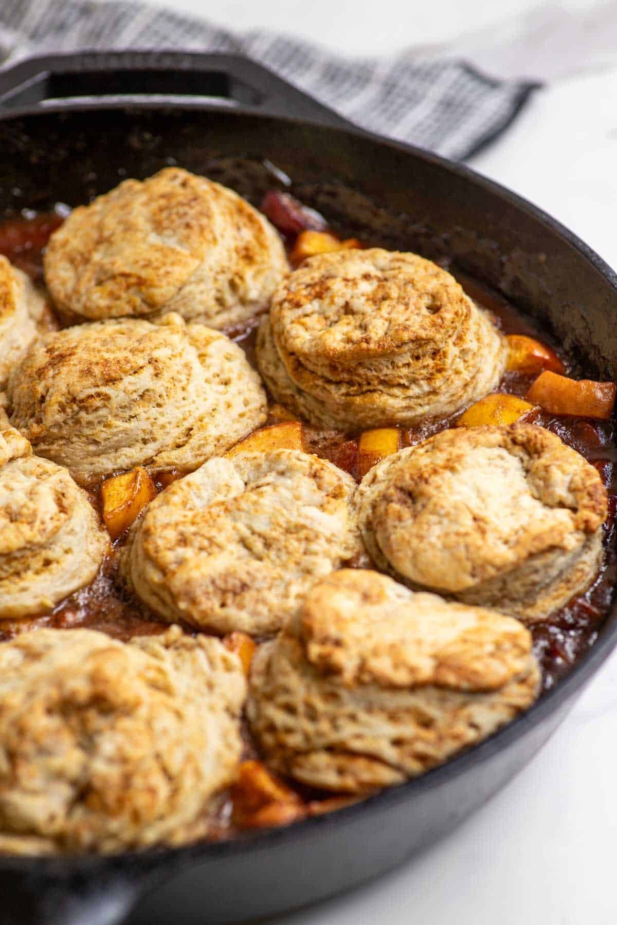 Sourdough peach cobbler in a cast iron skillet.