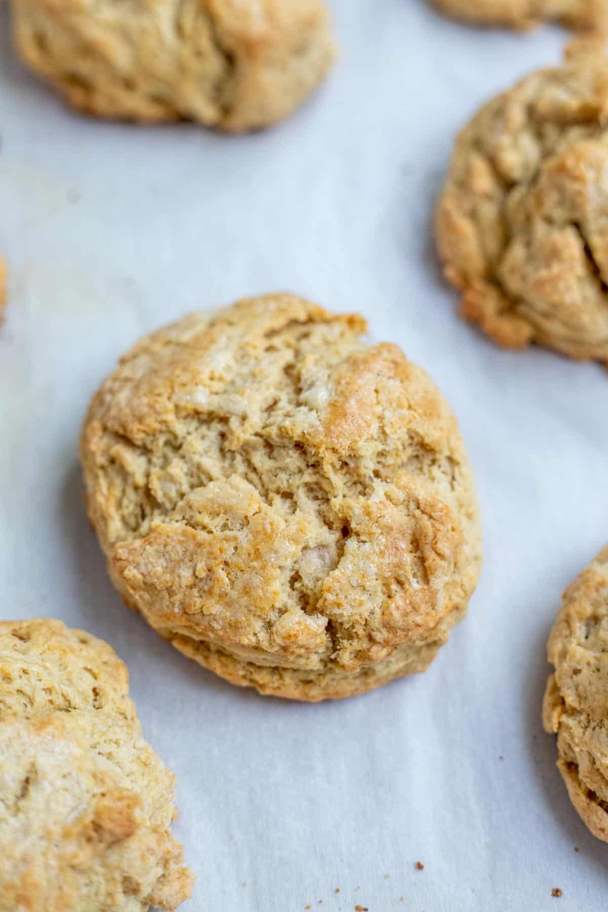 Baked sourdough shortcakes on a lined baking sheet.