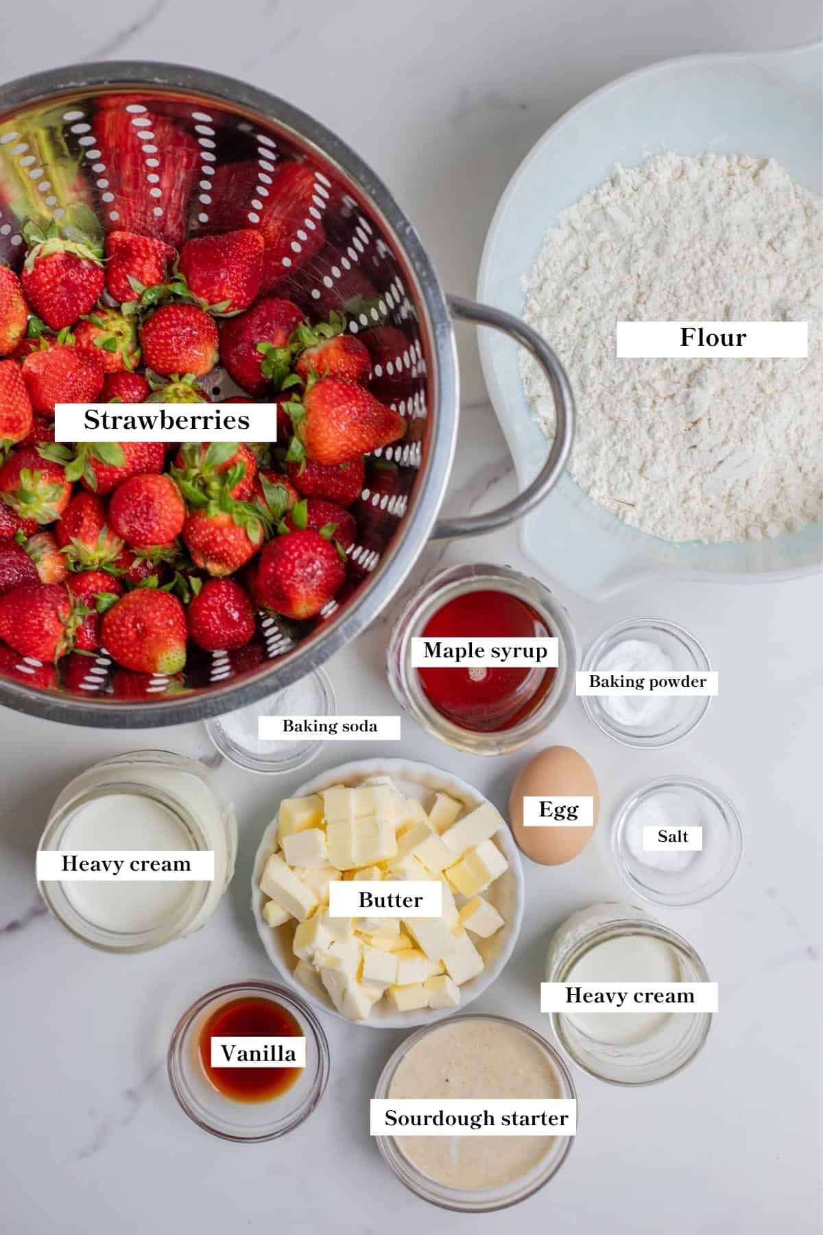 Ingredients for sourdough strawberry shortcakes in separate bowls.