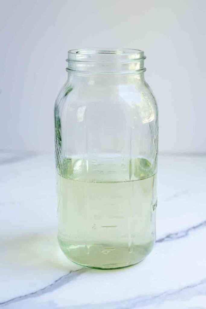 Water and melted sugar in a half gallon mason jar. 
