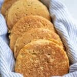 whole wheat crumpets in a tea towel lined basket.