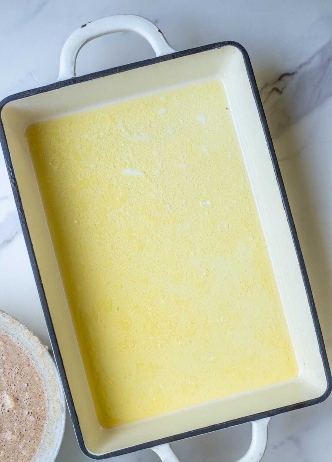 Butter melted in a 9" x 13" pan.