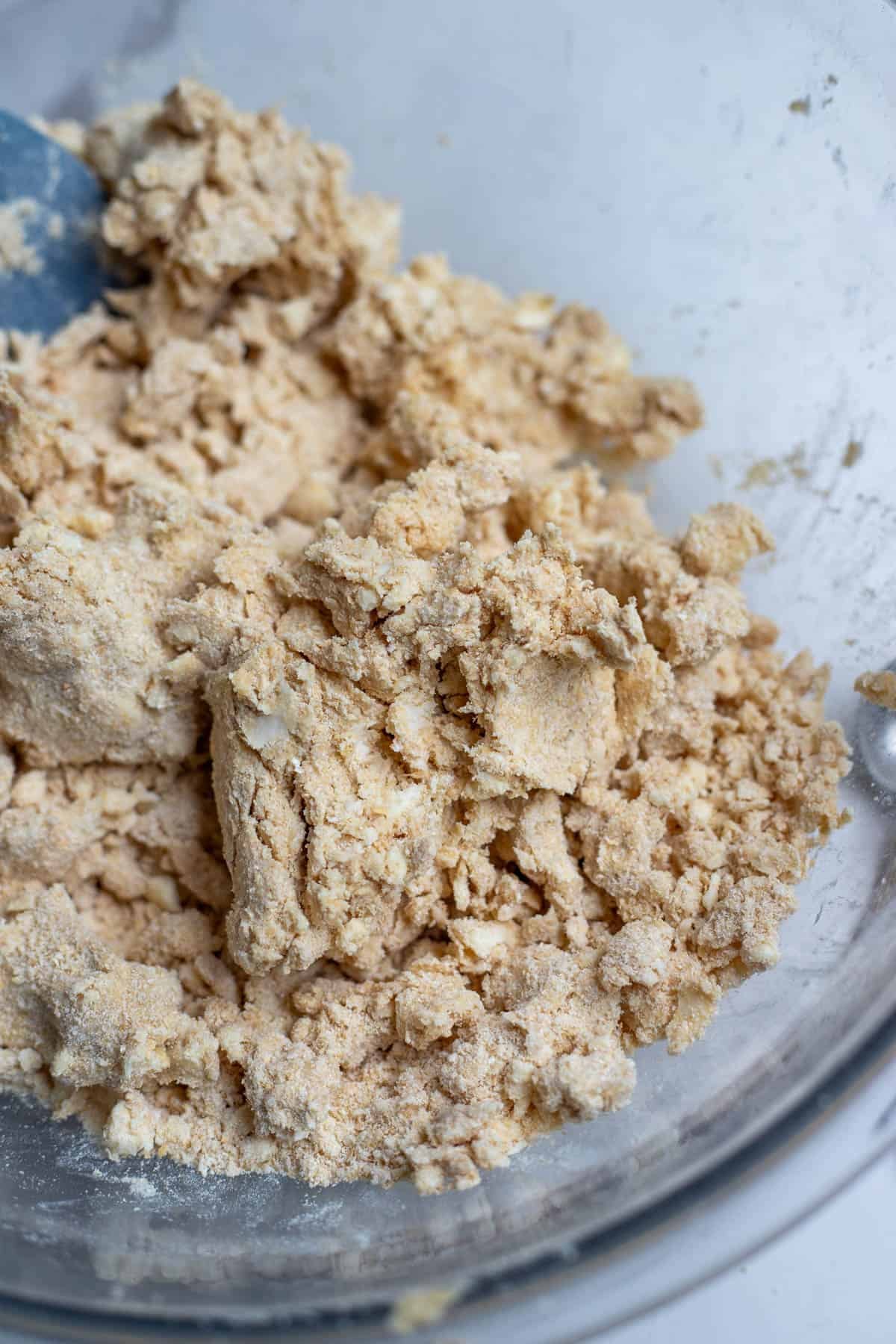 Cold butter incorporated with freshly milled flour in a large mixing bowl.