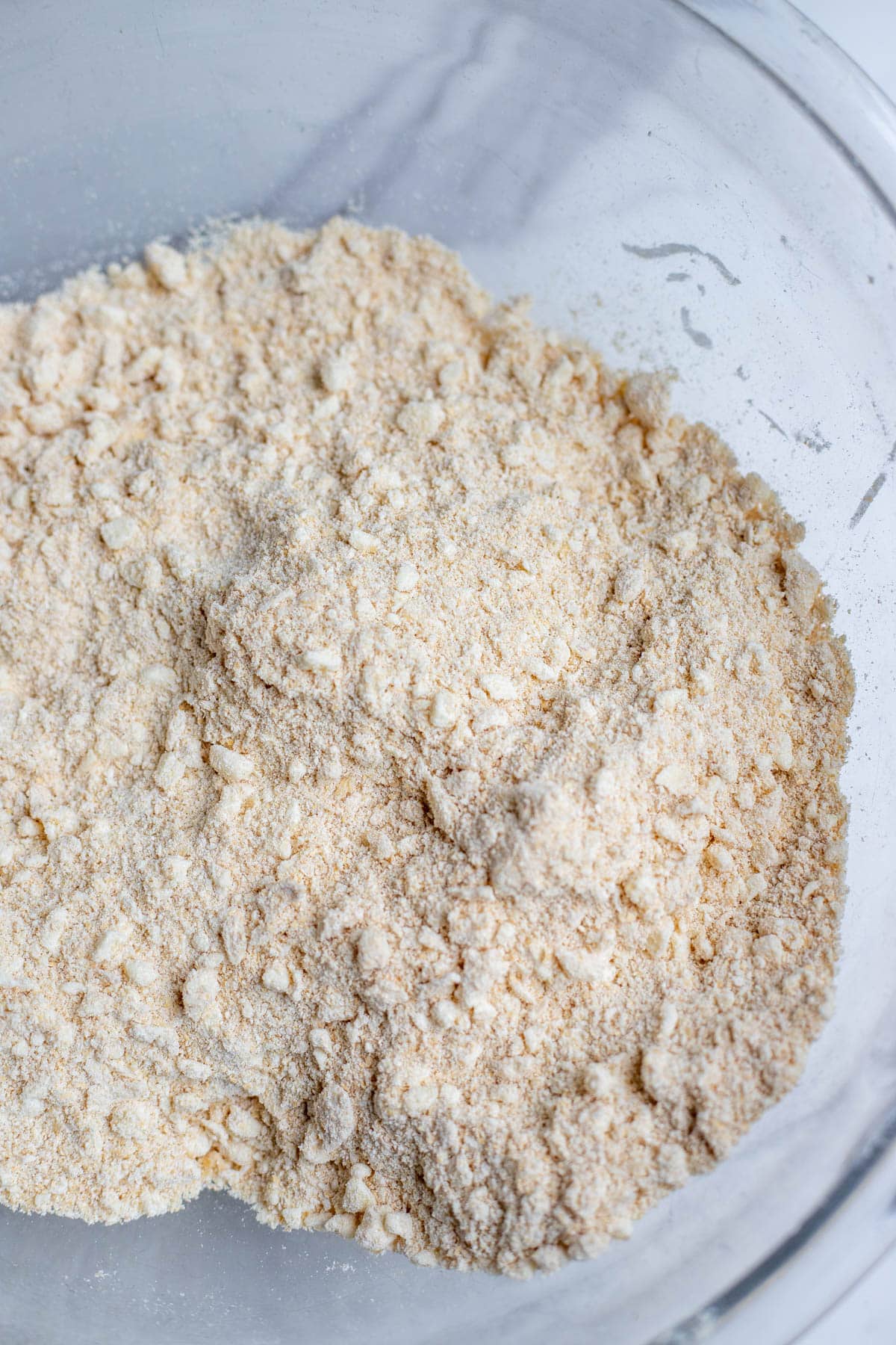 Freshly milled flour and salt in a large glass mixing bowl.