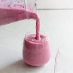 A blender being poured out into a glass.