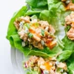 Lettuce cups with buffalo chicken salad in them on a serving platter.