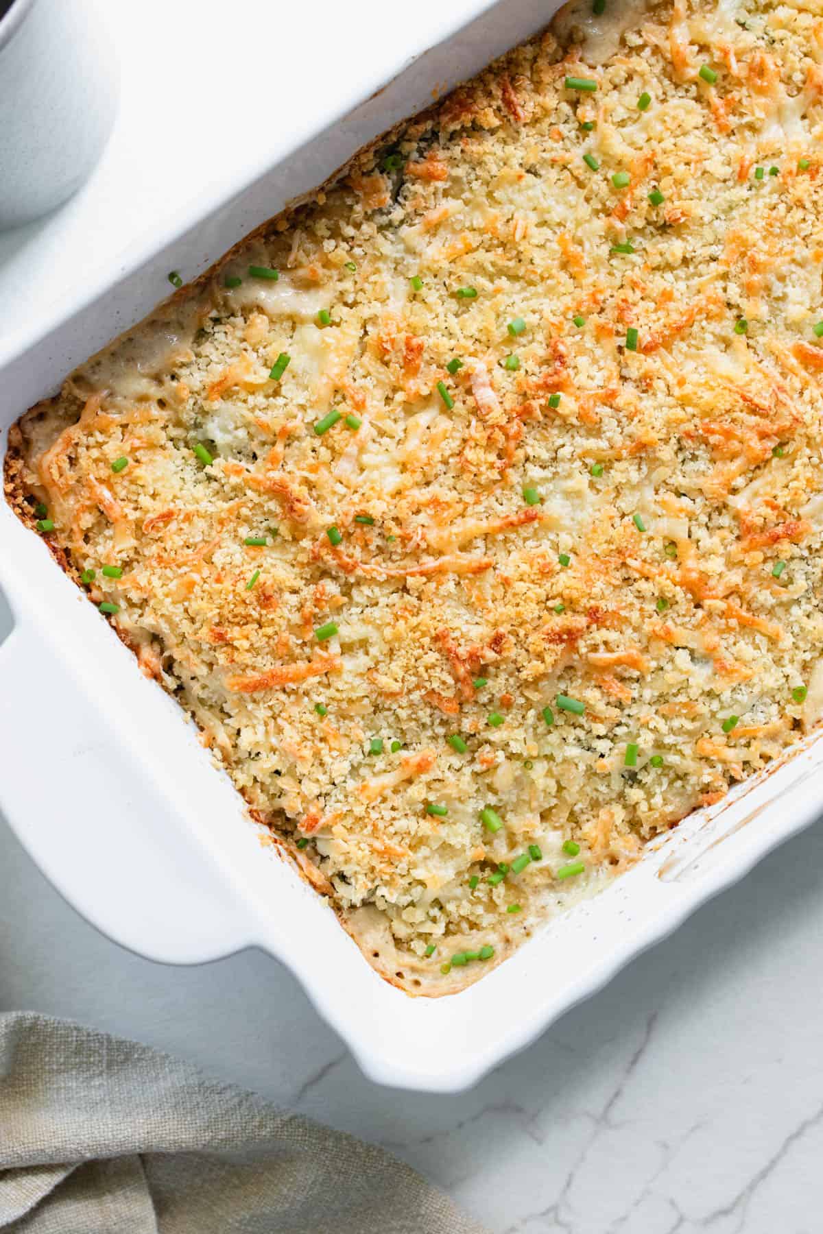 A casserole dish of zucchini gratin baked to golden brown.