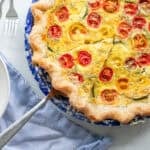 A pie plate with a zucchini quiche.